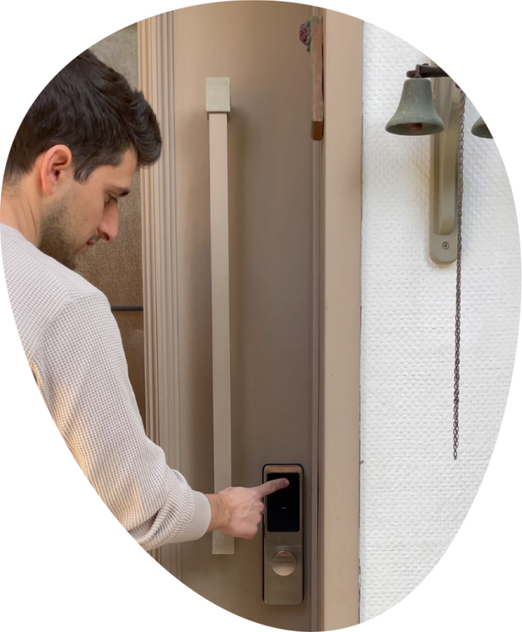 Man entering a code on a smart lock keypad installed on a front door